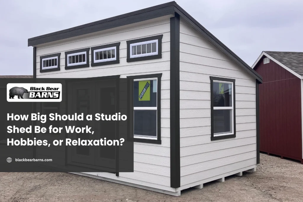 White studio shed with modern design, double doors, and transom windows by Black Bear Barns